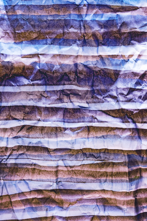 Background of colored crumpled paper shot close-upの写真素材