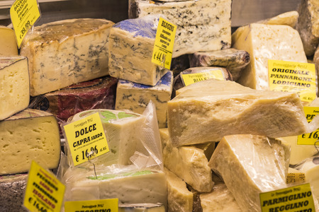 7 JUNE 2018, MILAN, ITALY: Showcases and shelves of the Wagner Market in Milan with many kinds of cheeses.のeditorial素材