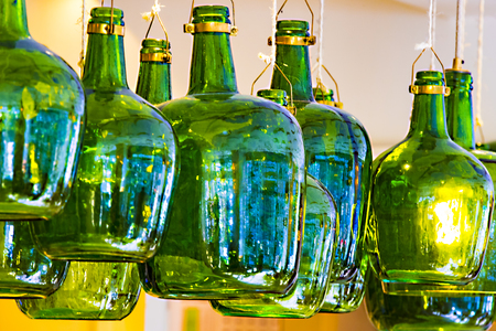 Lamps from old wine bottles against the ceilingの写真素材