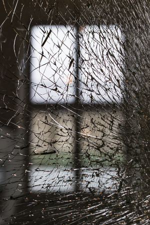 Background of broken transparent glass window close-up.の写真素材