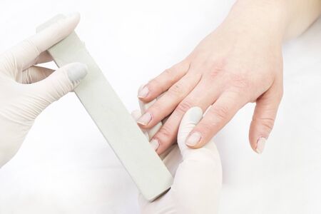 Female hand manicure procedure shot in closeup in a beauty salon.の写真素材