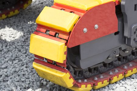 Caterpillars metal parts of the excavator shot close-up.