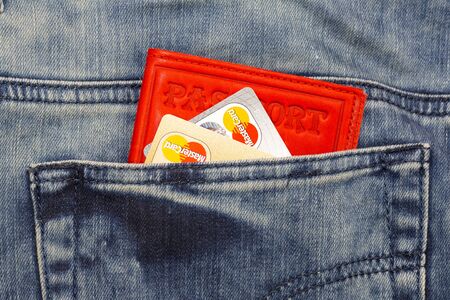 KHARKIV, UKRAINE - MARCH 16, 2016: Credit cards Visa and Mastercard sticking out of the pocket of jeans Lee.のeditorial素材