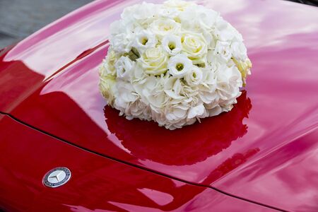 BUDAPEST, HUNGARY - AUGUST 19, 2017: Wedding bouquet on the background of the Mercedes Benz car emblem.のeditorial素材