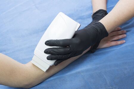 Procedure for waxing female parts of the body in a beauty salon.の写真素材