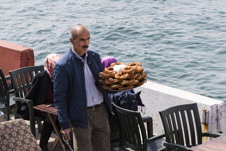 ISTANBUL, TURKEY - 5 APRIL, 2017: Street sales of traditional turkish bagels simit, are on the...