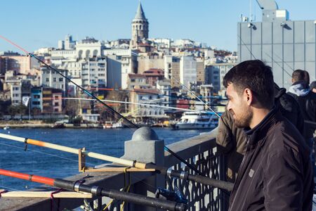 ISTANBUL, TURKEY - 1 APRIL, 2017: Fishermen on the Galata Bridge fish in the Golden Horn Bay Turkeyのeditorial素材