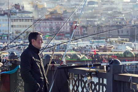 ISTANBUL, TURKEY - 1 APRIL, 2017: Fishermen on the Galata Bridge fish in the Golden Horn Bay Turkeyのeditorial素材