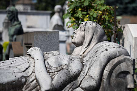 MILAN, ITALY - JUNE 6, 2018: Statues of mourning in Milan.