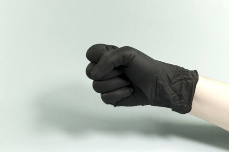 Hand gestures on a gray background in a sterile rubber glove shot with a large lan.の写真素材