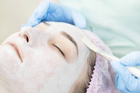 Procedure female cosmetic mask and chistak face in a beauty salon.