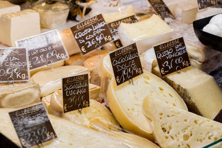 7 JUNE 2018, MILAN, ITALY: Showcases and shelves of the Wagner Market in Milan with many kinds of cheeses.のeditorial素材