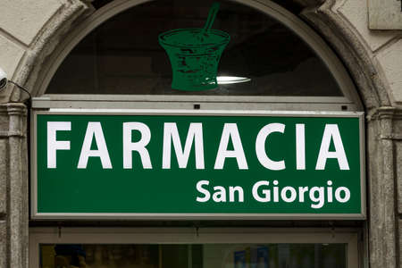 4 JUNE 2018, MILAN, ITALY: Signs of pharmacies on the streets of Milan. In Italy.のeditorial素材