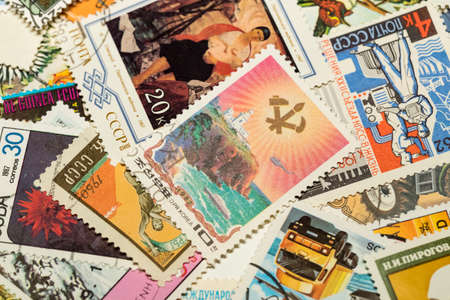 KHARKOV, UKRAINE - JUNE 23, 2020: Background of postage stamps used in different countries of the world shot closeup.のeditorial素材