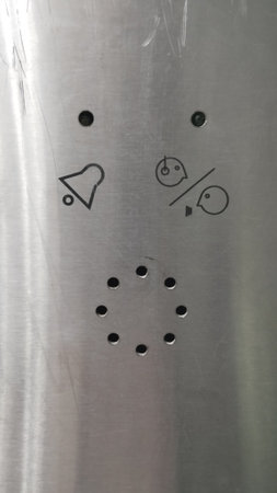 On the metal panel in the elevator: holes for negotiations with the operator, two light bulbs - one...