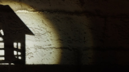 the silhouette of a house against a wall in the light of a flashlight, the image of a house with a...