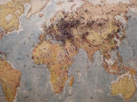 A world map with numerous pins marking placesの写真素材