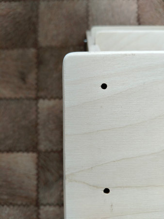wooden panel, a piece of furniture, with two holes for screws