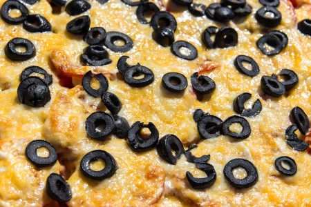 Closeup picture of pizza with olive and cheese.の写真素材