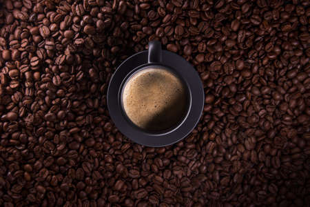 Cup of coffee in coffee beansの写真素材