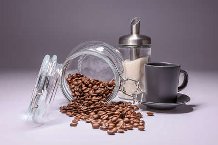 Cup, glass jar and sugar bowl on white backgroundの写真素材