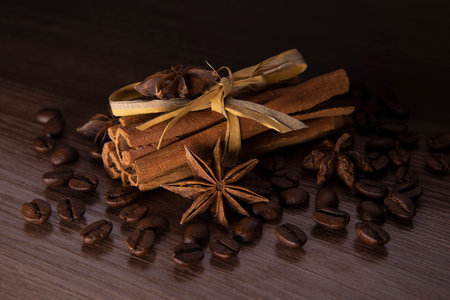 Cinnamon sticks, star anise and coffee on dark textured backgroundの写真素材