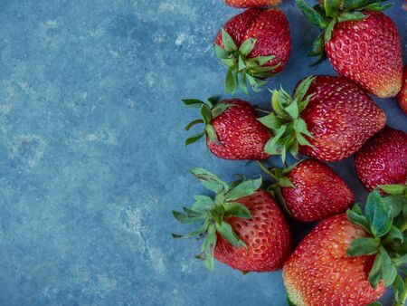 Fresh red strawberries on a blue background. Top view.の写真素材