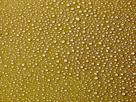 Water drops on gold background.の写真素材