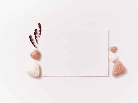 Postcard with handmade craft hearts and feather on white backgroundの写真素材