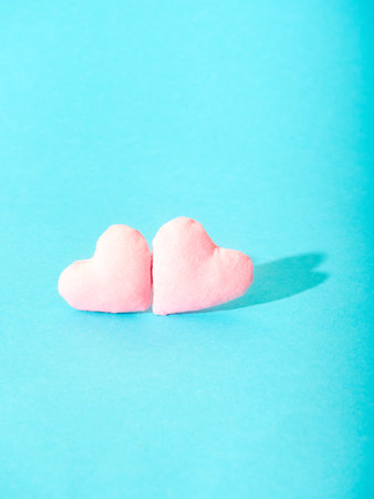 Handmade pink hearts on blue background.の写真素材