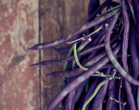 Purple asparagus beans on a wooden background.の写真素材