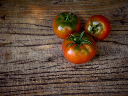 Fresh ripe tomatoes on wooden background.の写真素材