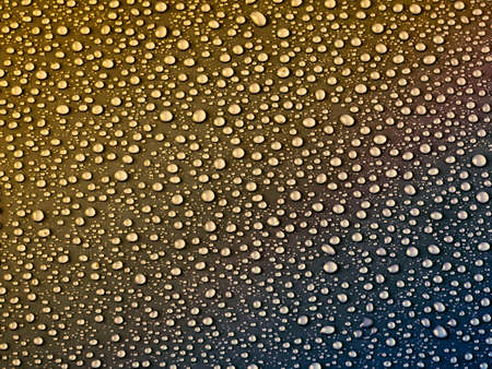 Water drops on gold background.の写真素材
