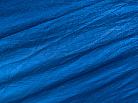 Blue abstract wrinkled fabric background with copy space, view from aboveの写真素材