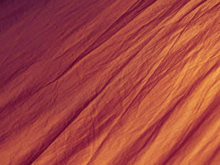 Red abstract wrinkled fabric background with copy space, view from aboveの写真素材