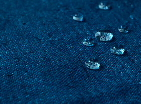 Water drops on blue waterproof fabric.の写真素材