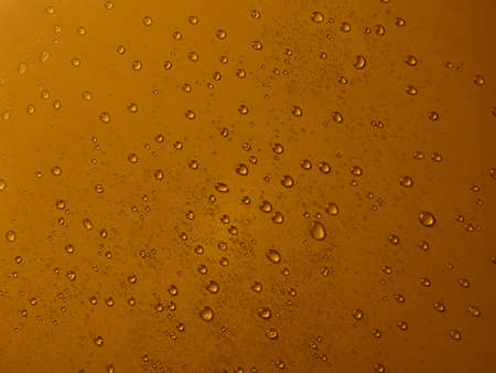 Random water drops on the gold PVC surfaceの写真素材
