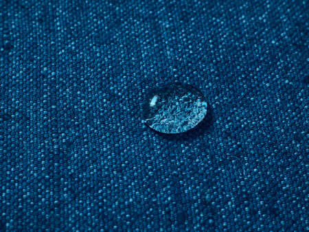 Water drops on blue waterproof fabric.の写真素材