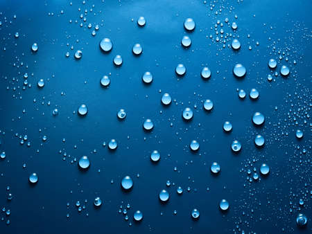 Water drops on blue background.の写真素材