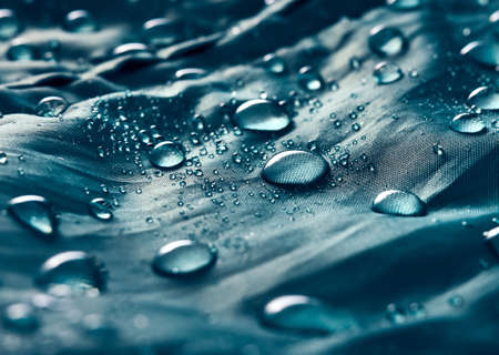 Water drops on blue fabric.の写真素材