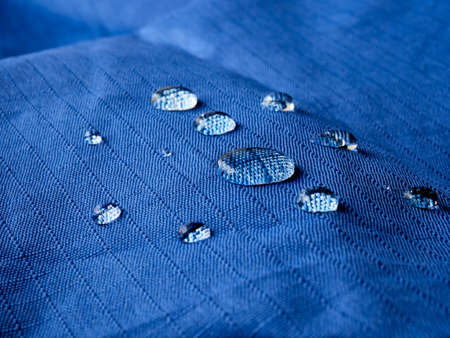Water drops on blue fabric.の写真素材