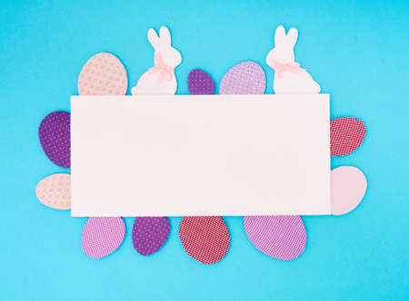 Easter greeting card. Paper blank on blue background. Flat lay, top view, copy space.の写真素材