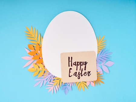 Easter greeting card. Paper blank on blue background. Flat lay, top view, copy space.