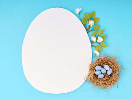 Easter greeting card with copy space. Paper blank on blue background.の写真素材