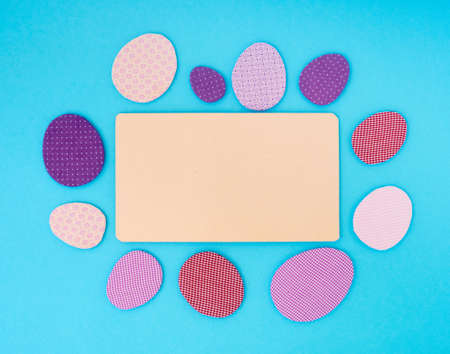 Easter greeting card. Paper blank on blue background. Flat lay, top view, copy space.の写真素材