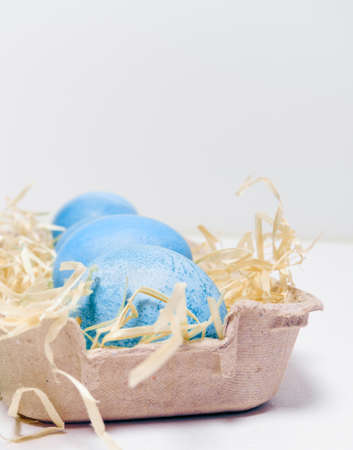 Easter eggs in a carton box on a white background.の写真素材