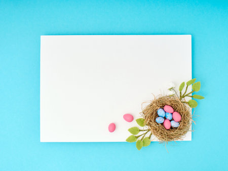 Easter greeting card with copy space. Paper blank on blue background.の写真素材