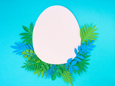 Easter greeting card. Paper blank on blue background. Flat lay, top view, copy space.の写真素材