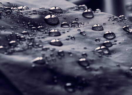 Water drops on waterproof membrane fabric. Detail view of waterproof cloth.の写真素材