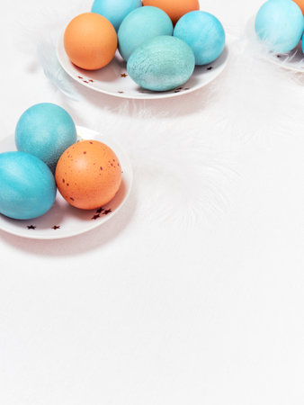 Colored eggs on plate with on white background. Copy space. Easter concept.の写真素材